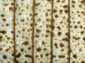 Cakes of baked matzo with a golden crust are laid out on a table with a vertical pattern. Royalty Free Stock Photo